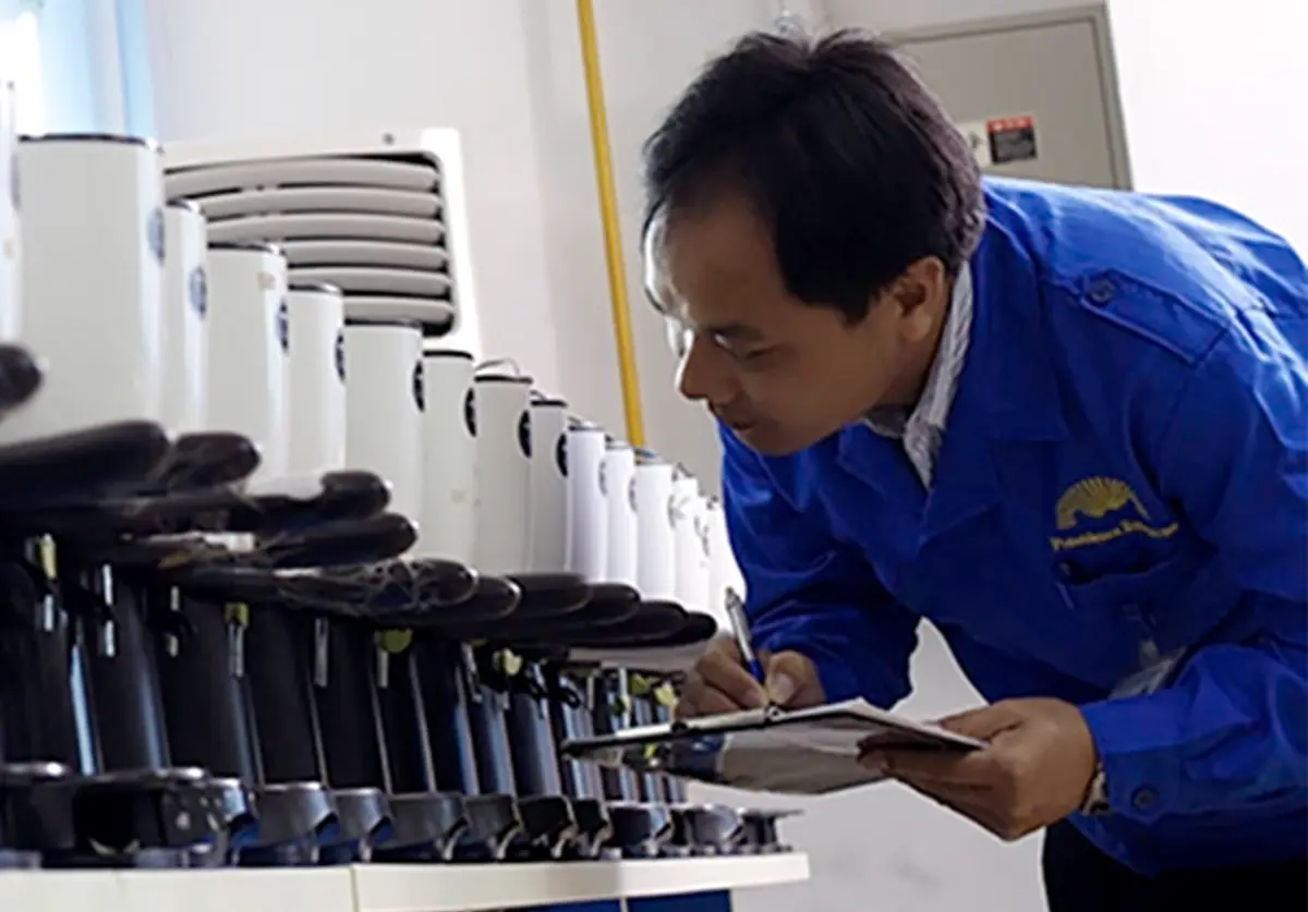 man inspecting coffee machines writing on clipboard