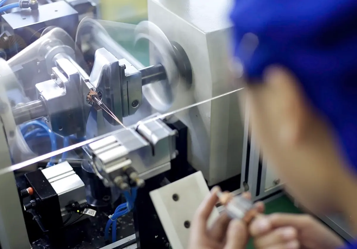 factory worker looking at machine