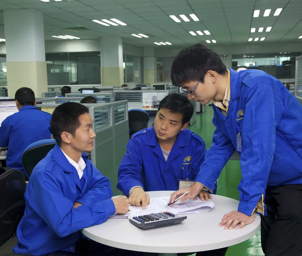 tooling engineers in meeting around table